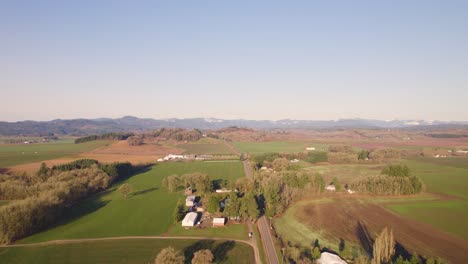 Aerial-pan-across-farmland,-farm,-and-country-homes-of-Carlton-Oregon
