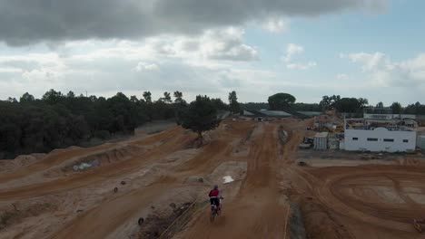 Dirt-motocross-track-with-ramps-and-two-riders-riding-on-it