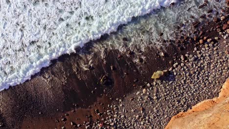 Beautiful-rocky-coastline-top-down-aerial-at-Playa-de-los-Guios-beach