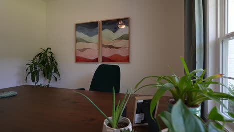 Plants-in-home-office-on-wooden-desk-for-health,-work-life-balance,-work-from-home,-orbiting-cinematic-shot