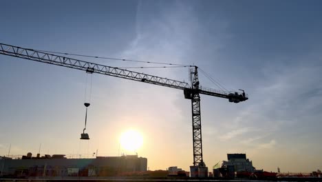 Crane-moving-heavy-loads-at-construction-site-in-city