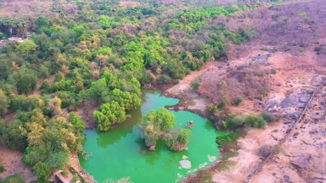 Little-river-in-the-middle-of-the-mountain,-Aerial-view,-and-People-swimming,-canoeing,-and-kayaking-in-cold-natural-water