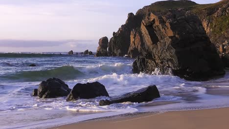 Golden-hour-shot-of-the-waves-and-the-headland-around-Dalmore-beach-near-Carloway