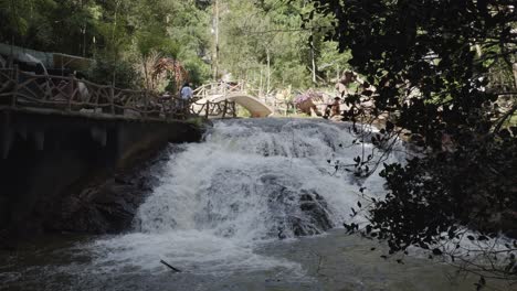 A-view-of-the-Datanla-waterfall-in-Da-Lat,-Vietnam,-with-a-small-bridge-visible-over-the-falls