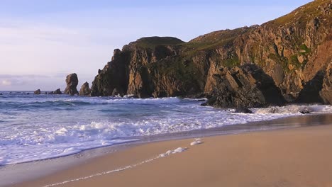 Golden-hour-footage-of-the-waves-and-the-headland-around-Dalmore-beach-near-Carloway