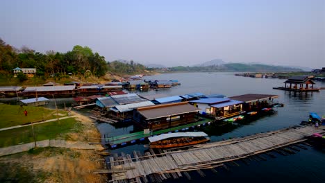 Wooden-houses-and-homes-floating-on-the-lake-with-boats