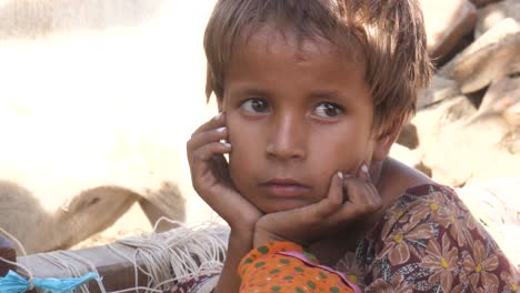 Young-Refugee-Girl-Sitting-Down-At-Make-Shift-Refugee-Camp-In-Maher-With-Hands-On-Face