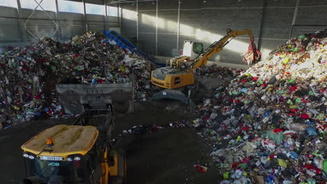 Trucks-at-work-in-indoor-waste-depot