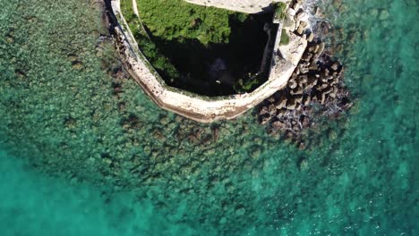 Aerial-Top-Down-Revealing-Castle-Ruins-On-Little-Island-Of-Souda-Bay,-Crete-Greece