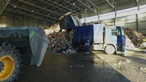 Waste-Truck-Emptying-Contents-At-Warehouse-Facility