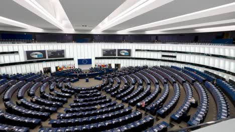 The-hemicycle-during-the-debates-at-the-plenary-session-in-the-European-Parliament-in-Strasbourg,-France---wide-angle-Panning-shot