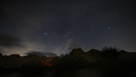 Timelapse-of-stars-in-front-of-Joshua-Trees-and-giant-boulders-in-National-Park
