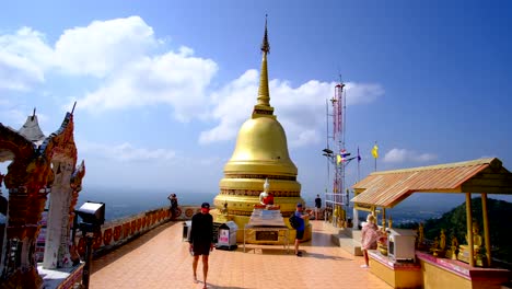 Tourist-attraction-in-Krabi-Budhha-temple-on-top-of-the-mountain-in-a-blue-bright-day-background