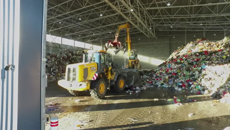 Bulldozer-Scoops-Up-A-Pile-Of-Plastic-Waste-In-Recycling-Factory