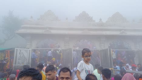 people-coming-out-of-temple-at-misty-day-from-flat-angle-video-is-take-at-pawagarh-gujrat-india-on-July-10-2022
