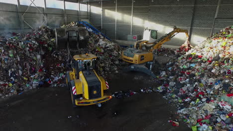 Bulldozer-Scoops-Up-A-Pile-Of-Plastic-Waste-In-Recycling-Factory