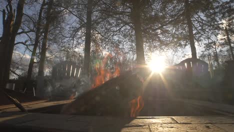 Fire-pit-slow-motion-with-sunset-backyard-trees
