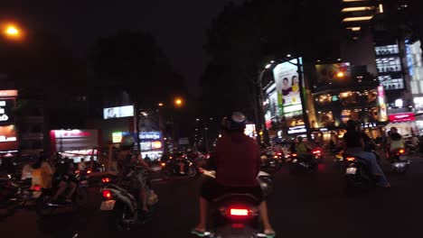 Night-motorbike-ride-in-heavy-traffic-in-Ho-Chi-Minh-City,-Vietnam