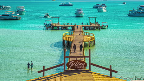 Time-Lapse-of-Giftun-Island,-Hurghada,-Egypt:-People-Bathing-at-Red-Sea-with-Yachts-Anchored-at-Orange-Bay