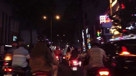 Night-motorbike-ride-in-traffic-in-Ho-Chi-Minh-City,-Vietnam