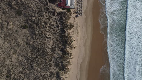 Drone-shot-of-Costa-da-Caparica-near-Lisbon---drone-is-flying-in-bird's-eye-view-over-the-beach