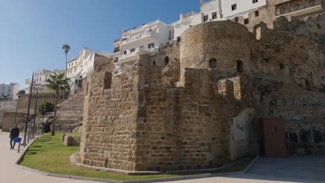 Pan-shot-of-Tangier's-old-town-port,-Majestic-fortress-walls,-Morocco