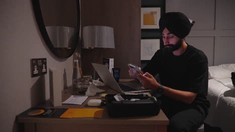 Busy-Man-Working-And-Using-Phone-Inside-The-Hotel-Bedroom