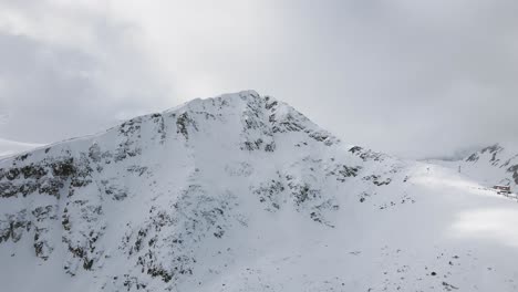 Panning-Slowmotion-panoramic-drone-shot-of-the-top-lift-of-the-Bansko-Ski-Resort,-in-Pirin-Bulgaria