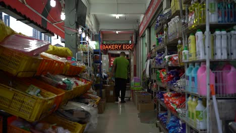 Worker-pushes-a-trolley-in-a-local-provision-shop-in-Little-India,-Singapore
