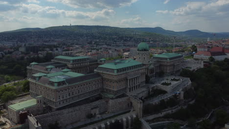 Drone-shot-of-Royal-Palace-in-Budapest,-Hungary---drone-is-descending-while-focusing-the-building