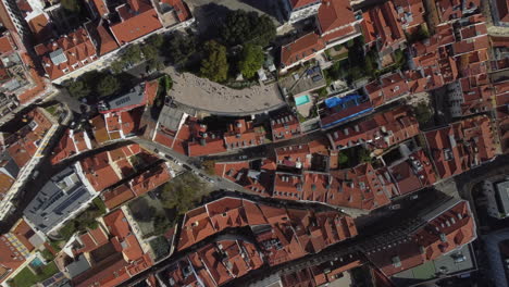 Drone-shot-of-Bairro-Alto-in-Lisboa---drone-is-ascending-in-bird's-eye-view-over-the-brick-coloured-roof