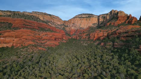 Wide-high-aerial-view-of-red-rock-mountains-flying-in-Sedona-Canyon