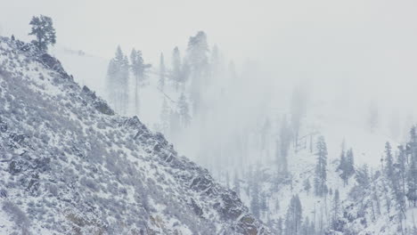 Layered-winter-fog-of-mountain-landscape-in-rocky-valley-with-steep-hills