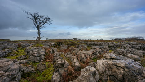 Timelapse-of-rural-nature-farmland-with-field-ground-rocks-in-the-foreground-during-cloudy-day-viewed-from-Carrowkeel-in-county-Sligo-in-Ireland