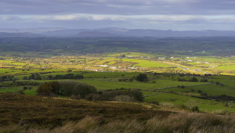 Timelapse-of-rural-nature-farmland-fields-with-hills-in-distance-during-sunny-cloudy-day-viewed-from-Carrowkeel-in-county-Sligo-in-Ireland