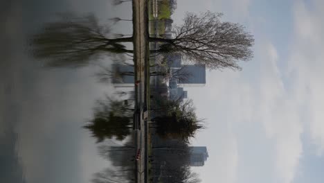 Vertical-Shot-In-Public-Park-With-Office-Buildings-On-The-Background