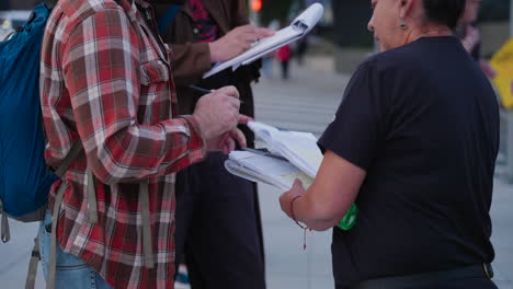 A-White-Man-Signs-a-Political-Waiver-in-Downtown