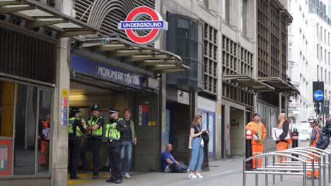 Monument-London-England-September-2022-Establishing-shot-of-Tube-station-as-police-and-people-mill-about-outside
