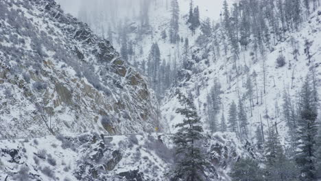 Truck-drives-on-rural-mountain-highway-in-winter-time-with-snow