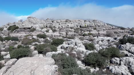 Flying-with-a-drone-through-the-natural-area-of-​​El-Torcal,-a-karst-area-located-in-Antequera-in-the-province-of-Malaga,-Spain