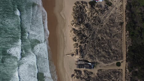 Drone-shot-of-Costa-da-Caparica-near-Lisbon---drone-is-ascending-in-bird's-eye-view-over-the-beach