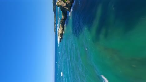 Fpv-flight-along-coastline-and-Beach-Breton-during-sunny-day-with-clear-water-of-sea-in-Dominican-Republic