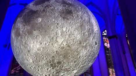 Tilt-up-shot-of-spectacular-Museum-of-the-Moon-Artwork-hanging-in-German-church