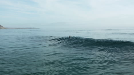 Lone-Foil-Surfer-being-Towed-into-a-Beautiful-Wave-and-Surfing