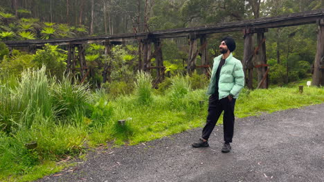 Sikhi-Man-Wearing-Black-Turban-With-Forest-And-Old-Bridge-At-The-Background