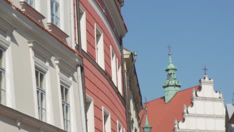 Slow-motion-pan-shot-of-typical-polish-buildings-and-a-church-on-a-sunny-day