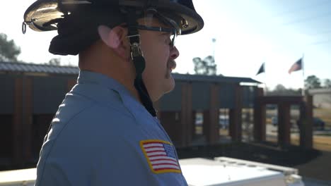 Firefighter-stands-in-early-morning-sunlight-ready-to-respond-to-emergencies-at-a-fire-department