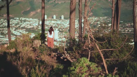Woman-is-walking-through-nature-on-top-of-a-hill