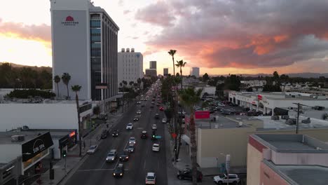 Aerial-view-overlooking-traffic-on-the-Ventura-blvd,-sunny-evening-in-LA,-USA