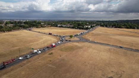 Rush-hour-traffic-Blackheath-London-UK-drone-aerial-view-in-summer-drought